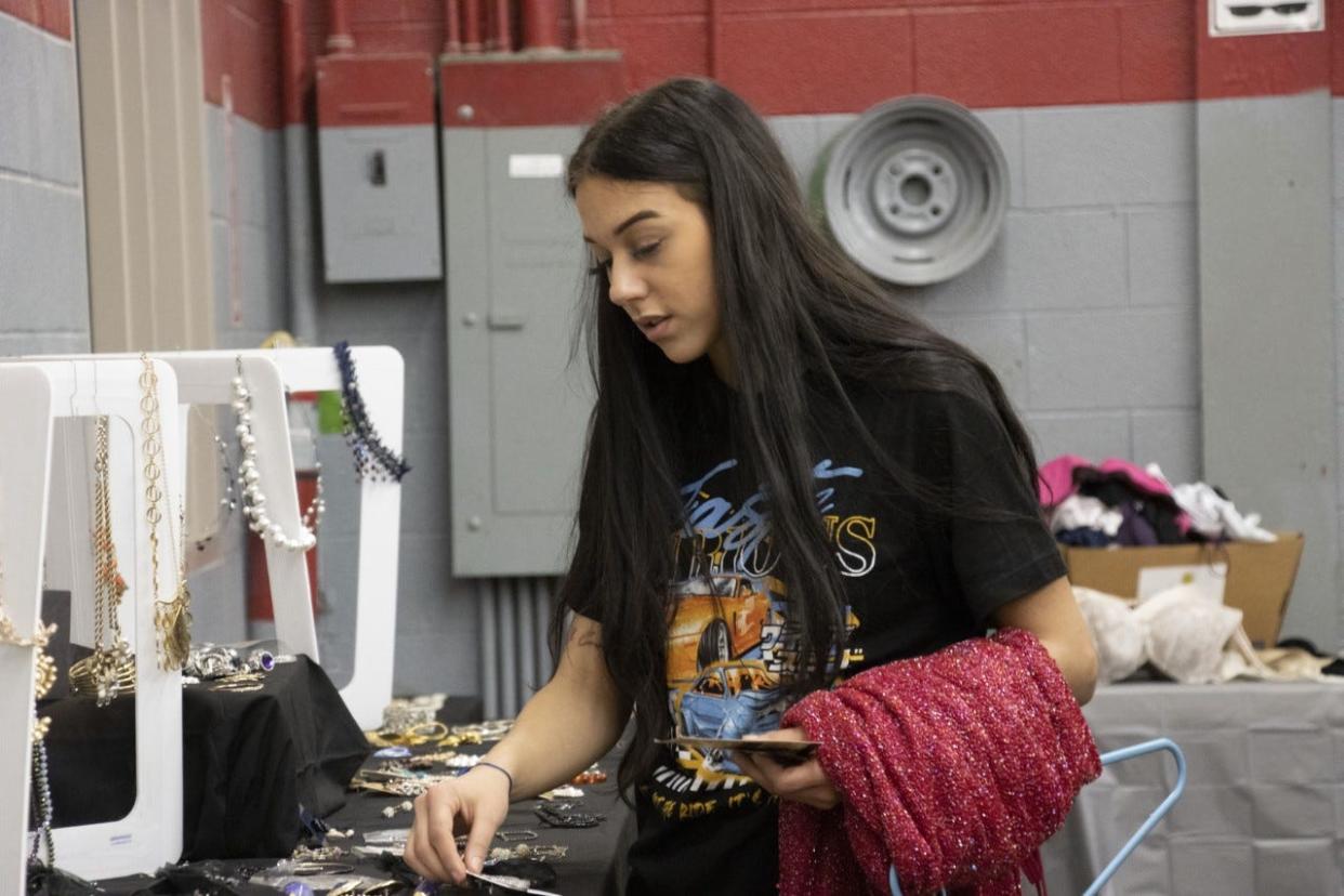 An Alliance High School student checks out jewelry while taking part in the March 17, 2023, Project Prom event at the school. Students are able to pick out prom dresses, shoes and accessories at no cost via the program.