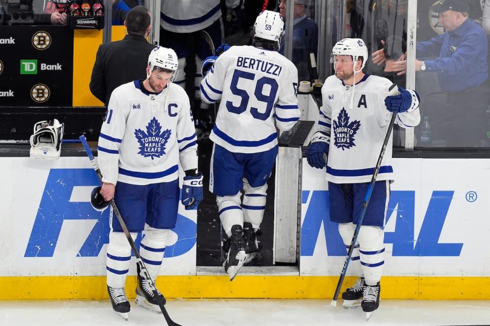 Toronto Maple Leafs' Tyler Bertuzzi (59) leaves the ice between John Tavares (91) and Morgan Rielly (44) after the team lost to the Boston Bruins in overtime, ending the Leafs' playoff run.
