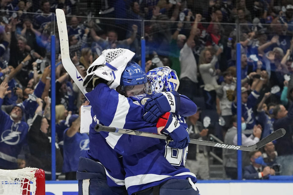 Tampa Bay Lightning defenseman Victor Hedman, left, and goaltender Andrei Vasilevskiy celebrate after defeating the New York Islanders in Game 7 of an NHL hockey Stanley Cup semifinal playoff series Friday, June 25, 2021, in Tampa, Fla. (AP Photo/Chris O'Meara)