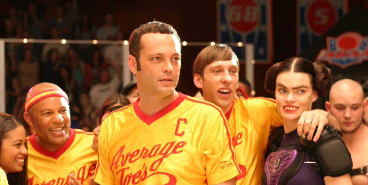 dodgeball a true underdog story cast all wearing their sports outfits, with vince vaughn in the middle