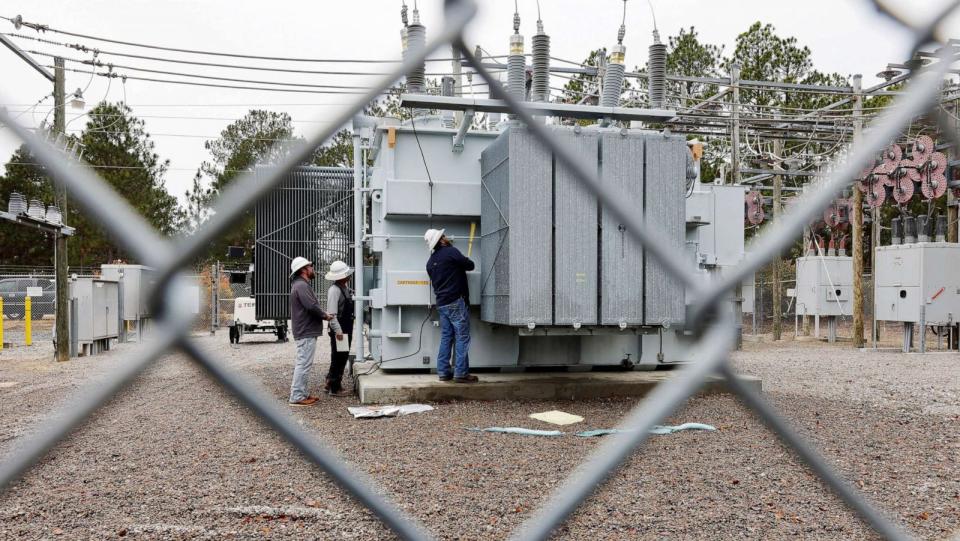 PHOTO: Duke Energy workers inspect a transformer radiator that they said was damaged by gunfire that crippled an electrical substation after the Moore County Sheriff said that vandalism caused a mass power outage, in Carthage, N.C. (Jonathan Drake/Reuters, FILE)