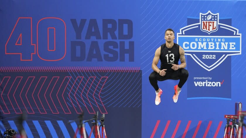 Cincinnati quarterback Desmond Ridder jumps before he runs the 40-yard dash during.