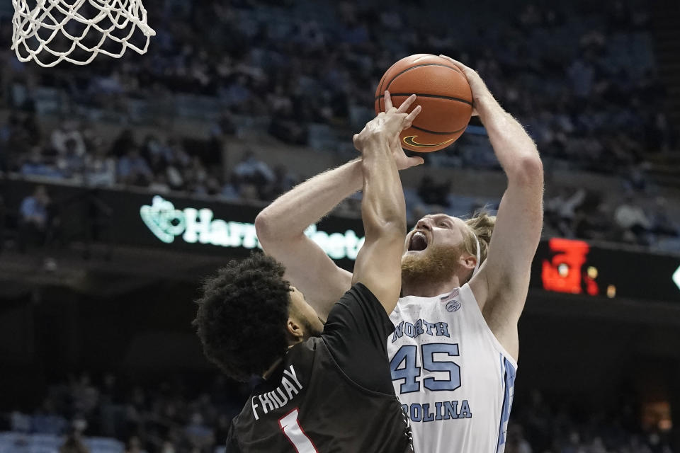 North Carolina forward Brady Manek (45) shoots while Brown guard Dan Friday (1) defends during the first half of an NCAA college basketball game in Chapel Hill, N.C., Friday, Nov. 12, 2021. (AP Photo/Gerry Broome)