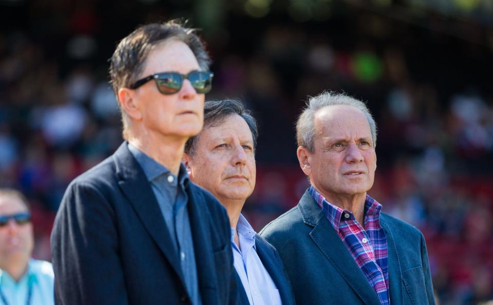 BOSTON, MA - SEPTEMBER 27: John Henry, Tom Werner and Larry Lucchino watch a video tribute as Lucchino was being honored for his last home game as Red Sox CEO/President before a game against the Baltimore Orioles  Fenway Park on September 27, 2015 in Boston, Massachusetts. The Red Sox won 2-0. (Photo by Rich Gagnon/Getty Images)