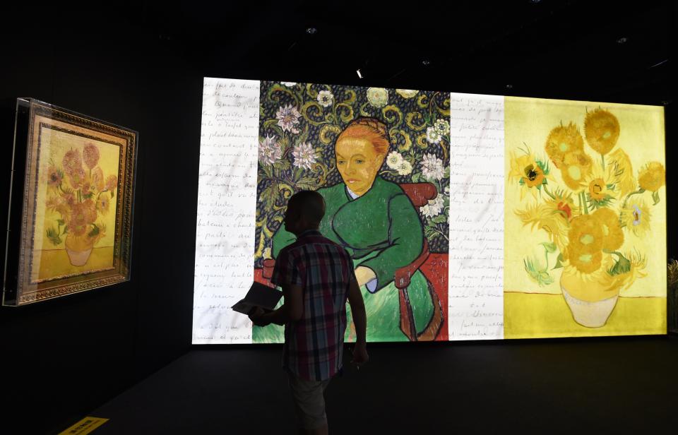 Visitors walk through an exhibition about the life and works of Dutch painter Vincent van Gogh, in Beijing on June 16, 2016. The exhibition, titled "Meet Vincent van Gogh," was created by the Van Gogh Museum and had its global launch in Beijing on June 15. Featuring reproductions of his work and recreations of scenes he painted, the exhibition is scheduled to tour cities across Greater China over the next five years.