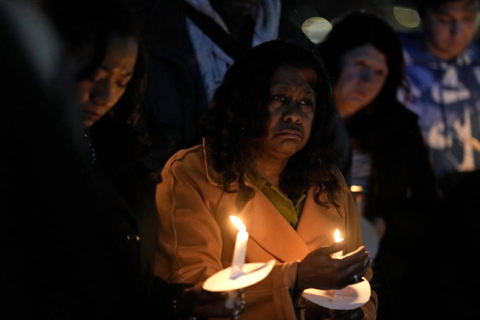 A woman holds a candle at the Kansas City, Missouri vigil (Copyright 2024 The Associated Press. All rights reserved)