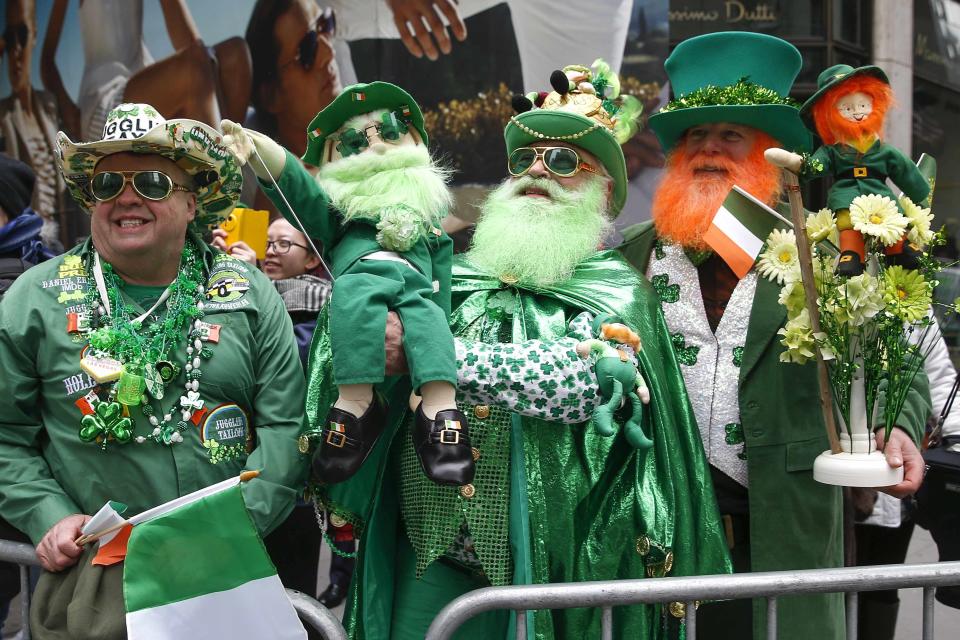 People stand along 5th avenue during the St. Patrick's Day parade in New York