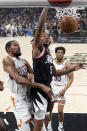 Los Angeles Clippers guard Bones Hyland, center, dunks as Phoenix Suns forward Kevin Durant, left, and forward Thaddeus Young defend during the first half of an NBA basketball game Wednesday, April 10, 2024, in Los Angeles. (AP Photo/Mark J. Terrill)