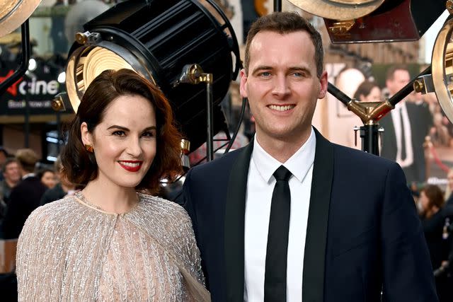 <p>Dave J Hogan/Getty </p> Michelle Dockery and Jasper Waller-Bridge pose for a photo at the 'Downton Abbey: A New Era' premiere in April 2022