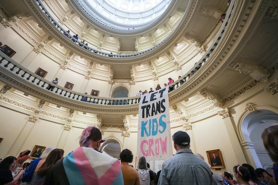 Equality Texas leadership drops a banner in the Capitol rotunda reading "let trans kids grow up" as LGBTQ rights activists protest SB14 at the Capitol of Texas Tuesday, May 2, 2023. SB14 would ban gender-affirming medical care for transgender children.