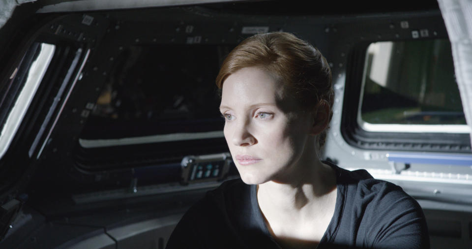 soft light falls on Melissa's face as she works from the control panel at the front of the ship