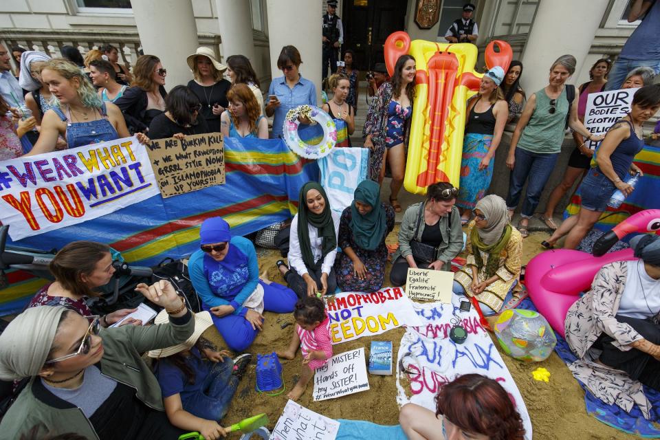 Protesters from different societies stage a demonstration outside the French Embassy in London, to show support for Muslim women on Aug. 25, 2016, after 15 French towns introduced and started to enforce a ban on the burkini.