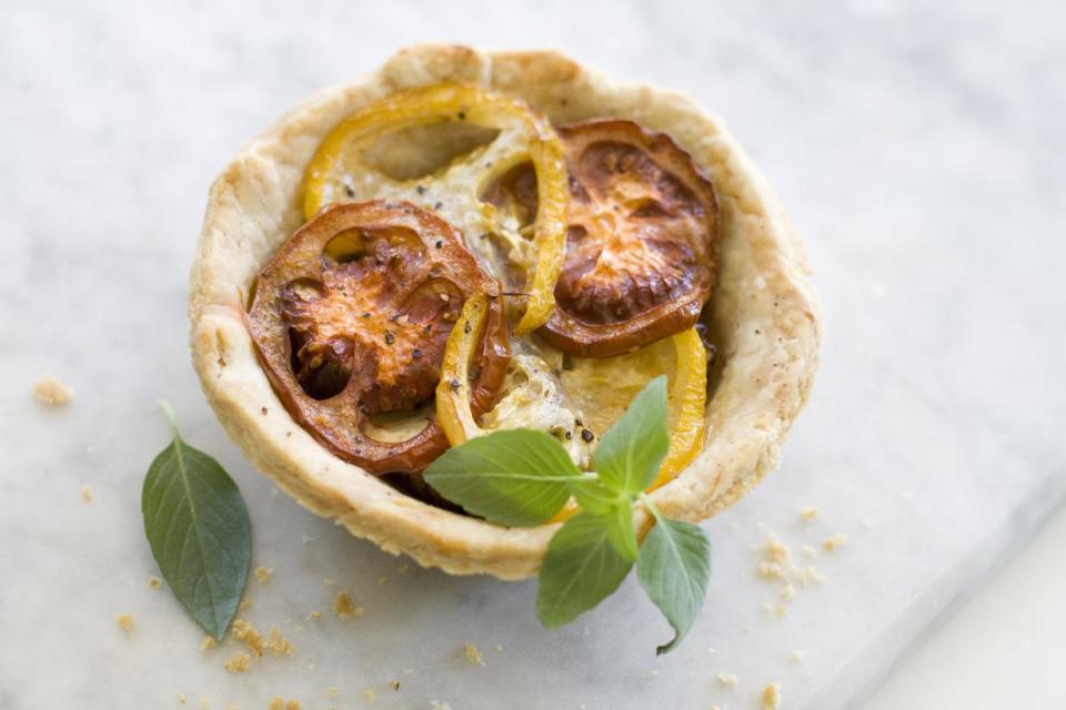 Caramelized Onion, Eggplant and heirloom tomato tart.This Aug. 5, 2013 photo shows caramelized onion, eggplant and heirloom tomato tart in Concord, N.H. (AP Photo/Matthew Mead)