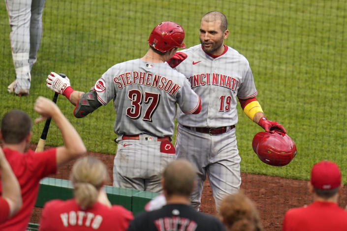 Cincinnati Reds' Joey Votto (19) celebrates with Tyler Stephenson as he returns to the dugout after hitting a three-run home run off Pittsburgh Pirates starting pitcher Cody Ponce (44) during the fifth inning of a baseball game in Pittsburgh, Sunday, Oct. 3, 2021. (AP Photo/Gene J. Puskar)