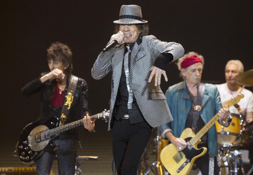 Mick Jagger, center, Keith Richards, Ronnie Wood, left, and Charlie Watts, right, of The Rolling Stones perform at the O2 arena in east London, Sunday, Nov. 25, 2012. The band are playing four shows to celebrate their 50th anniversary, including two shows at London’s O2 and two more in New York. (Photo by Joel Ryan/Invision/AP)