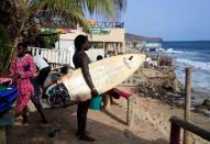 Wider Image: Meet Senegal's first female pro surfer inspiring girls to take to the waves