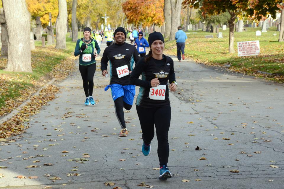 Run of the Dead participants running through historic Holy Cross and Woodmere Cemetery.