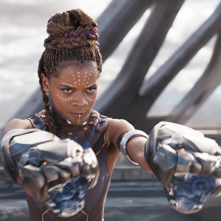 Shuri fighting in the first Black Panther film with tribal markings on her face