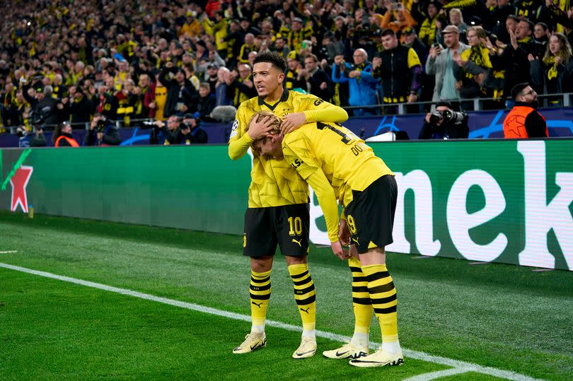 Jadon Sancho celebrates with Julian Brandt as Borussia Dortmund qualify for the Champions League semi-finals