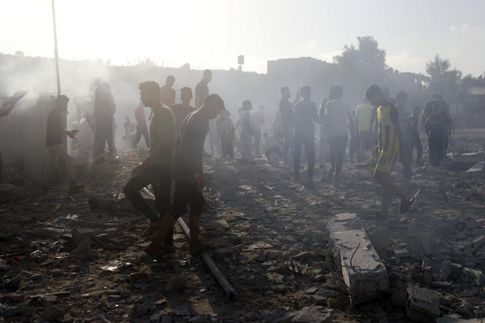 FILE - Palestinians inspect the damage of a destroyed mosque following an Israeli airstrike in Khan Younis refugee camp, southern Gaza Strip on Nov. 8, 2023. Entire generations of Palestinian families in the besieged Gaza Strip have been killed in airstrikes in the ongoing Hamas-Israel war. They include infants to elderly grandparents, killed in attacks the Israeli army says aim to root out the militant group from the densely populated coastal territory.(AP Photo/Mohammed Dahman, File)