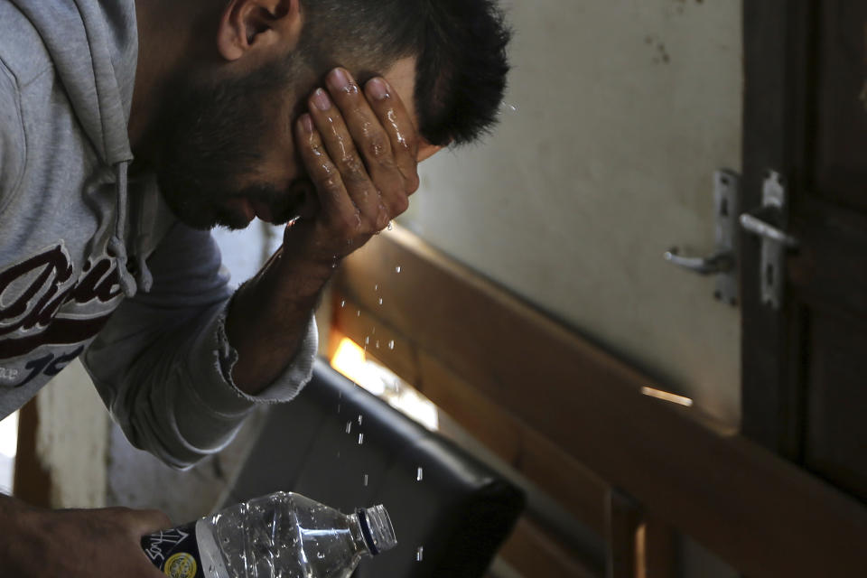 In this Tuesday, Nov. 20, 2018, Hawye Rasool Saleh, 32, a migrant from Iraq washes his face at his living space under a hotel in central Nicosia, Cyprus. Cyprus was not seen as an attractive destination for migrants seeking shelter and a new life in Europe, but that has changed as other nations in Europe have shut their borders and the economic situation has slowly improved for this small island nation.(AP Photo/Petros Karadjias)