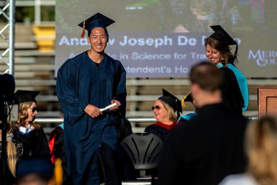 Graduates make their way across the stage during a commencement ceremony for the Merced College class of 2022 on the Don Odishoo Field at Stadium ’76 in Merced, Calif., on Friday, May 20, 2022.