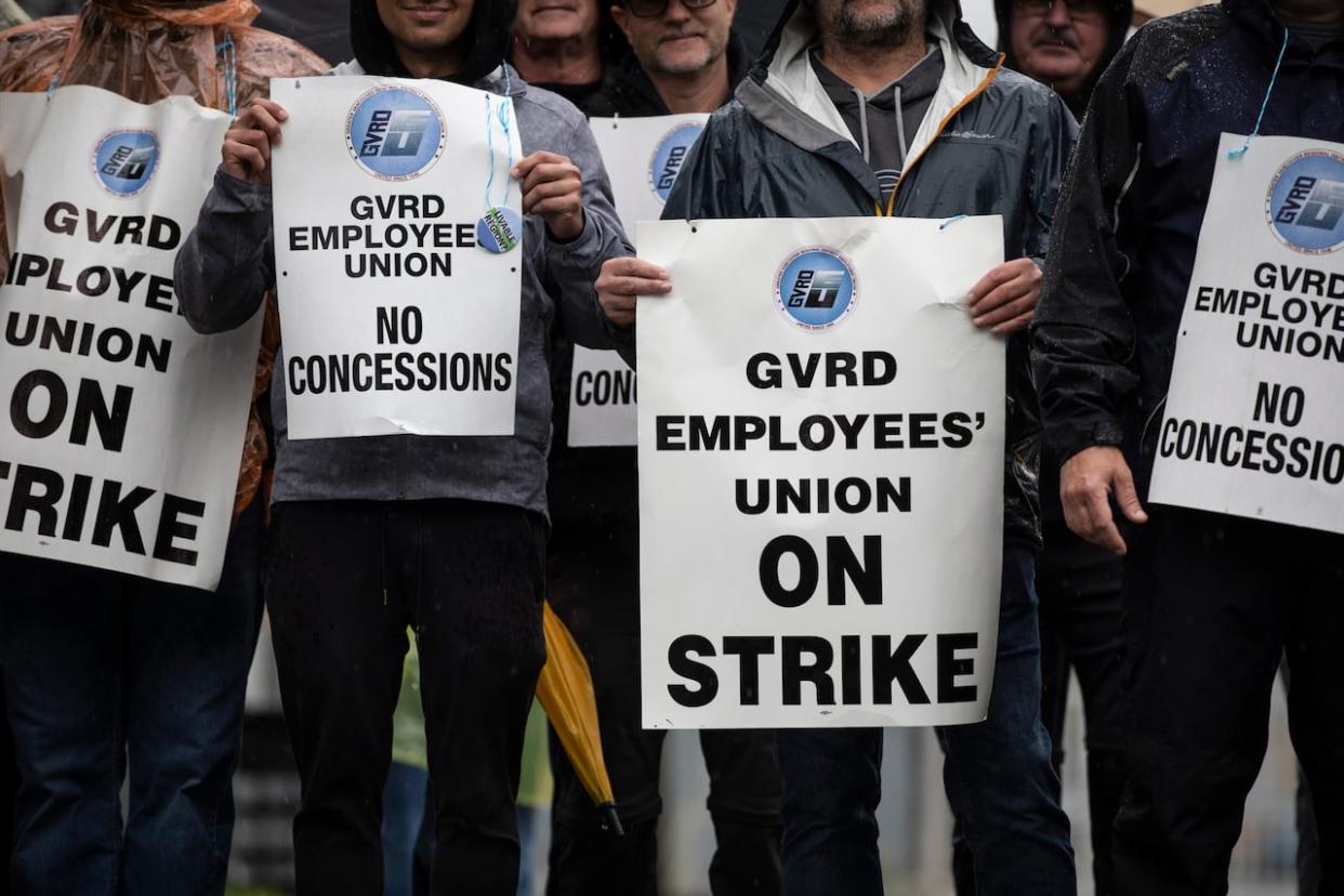Workers with the Greater Vancouver Regional District Employees' Union on strike at the Annacis Island wastewater treatment plant in Delta, B.C., on Monday.  (Ben Nelms/CBC News - image credit)