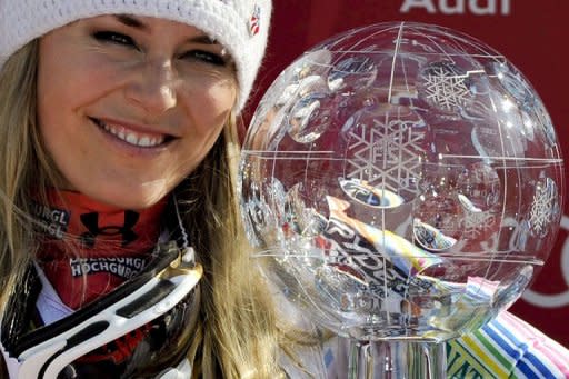 Lindsey Vonn from the US poses with her overall World Cup crystal globe during the podium ceremony of the FIS Alpine Skiing World Cup in Schladming, Austria, on Sunday