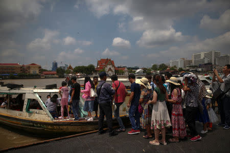 FILE PHOTO - Chinese tourists board a sightseeing boat at a pier at Chao Phraya River in Bangkok, Thailand, October 3, 2016. REUTERS/Athit Perawongmetha/File Photo