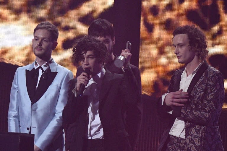 (L-R) Adam Hann, Ross MacDonald, Matty Healy and George Daniel of the British rock band 'The 1975' talk on stage after receiving the award for a British group during the BRIT Awards 2017 ceremony and live show in London on February 22, 2017