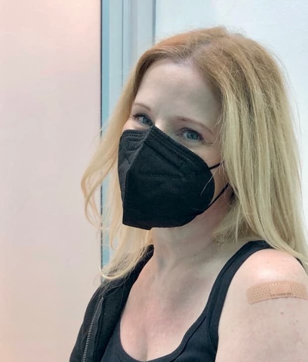 Leah Noster, posing here after her second COVID-19 vaccine, struggles with extreme fatigue seven months after her initial COVID-19 diagnosis. A Calgary researcher is looking at how chronic fatigue impacts patients like Noster. (Submitted by Leah Noster - image credit)