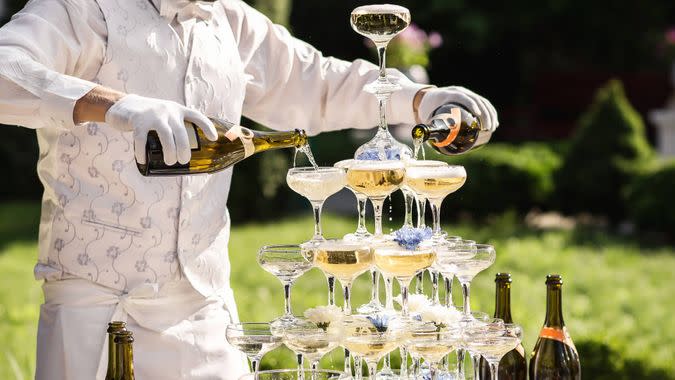 wedding server pouring champagne