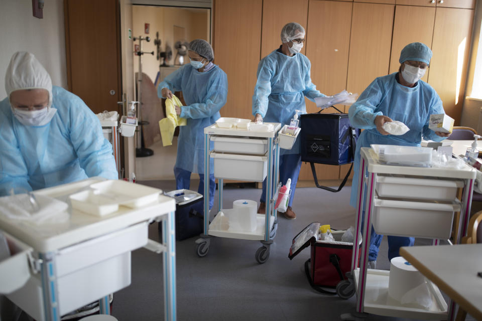 Medical staff from a private laboratory arrive to test the residents at a nursing home in Kaysesberg, France Thursday April 16, 2020. An Associated Press photographer spent two days chronicling the virus testing at three of the 10 nursing homes in France's Haut-Rhin region, where comprehensive testing was ordered by local authorities. (AP Photo/Jean-Francois Badias)