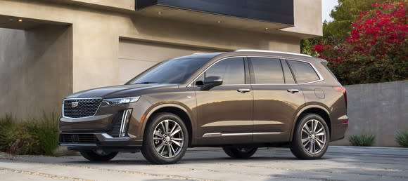 A brown 2020 Cadillac XT6 in Premium Luxury trim. It has smaller wheels and subtler styling cues than the Sport version pictured above.