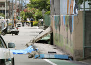 <p>Wall lies on road after it fell down following an earthquake near an elementary school in Takatsuki, Osaka, Monday, June 18, 2018. A strong earthquake knocked over walls and set off scattered fires around the city of Osaka in western Japan on Monday morning. (Photo: Shuichiro Sugiyama/Kyodo News via AP) </p>