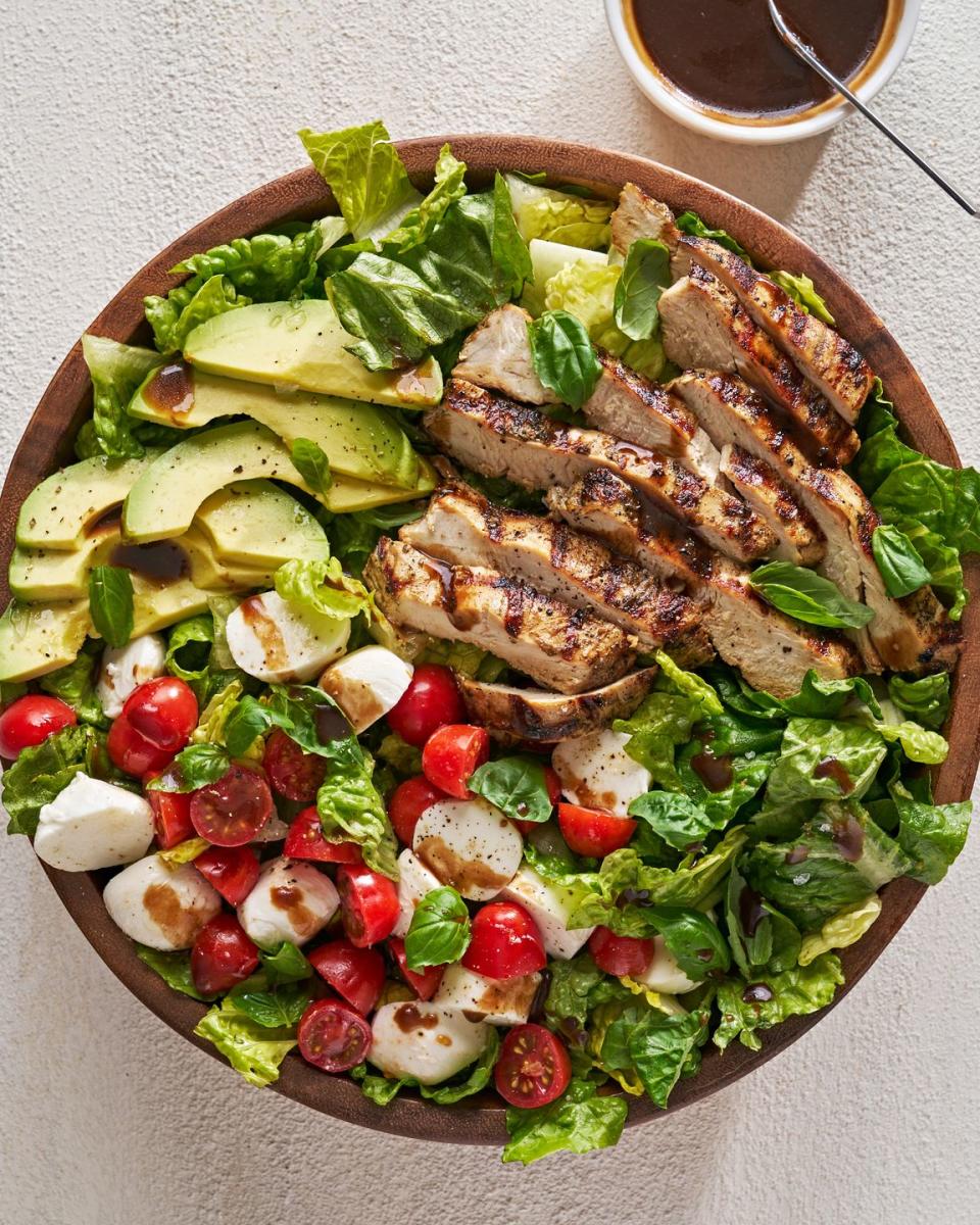 <p>Though we’re all about a <a href="https://www.delish.com/cooking/nutrition/g2599/healthy-dinner-salads/" rel="nofollow noopener" target="_blank" data-ylk="slk:healthy salad;elm:context_link;itc:0;sec:content-canvas" class="link ">healthy salad</a> chock-full of delicious ingredients, sometimes we’re more about quality than quantity. Possibly the most quintessential example of this is the <a href="https://www.delish.com/cooking/recipe-ideas/a19695744/easy-caprese-salad-recipe/" rel="nofollow noopener" target="_blank" data-ylk="slk:Caprese salad;elm:context_link;itc:0;sec:content-canvas" class="link ">Caprese salad</a>, made up of just three ingredients—fresh <a href="https://www.delish.com/cooking/g40048963/mozzarella-recipes/" rel="nofollow noopener" target="_blank" data-ylk="slk:mozzarella;elm:context_link;itc:0;sec:content-canvas" class="link ">mozzarella</a>, gorgeous <a href="https://www.delish.com/cooking/g1448/quick-easy-tomato-recipes/" rel="nofollow noopener" target="_blank" data-ylk="slk:tomatoes;elm:context_link;itc:0;sec:content-canvas" class="link ">tomatoes</a>, and bright <a href="https://www.delish.com/cooking/recipe-ideas/g40396015/fresh-basil-recipes/" rel="nofollow noopener" target="_blank" data-ylk="slk:basil;elm:context_link;itc:0;sec:content-canvas" class="link ">basil</a>. To make this chicken-avocado version, we stuck with that principle, just adding grilled <a href="https://www.delish.com/cooking/recipe-ideas/recipes/a49138/balsamic-glazed-chicken/" rel="nofollow noopener" target="_blank" data-ylk="slk:balsamic chicken;elm:context_link;itc:0;sec:content-canvas" class="link ">balsamic chicken</a>, creamy <a href="https://www.delish.com/cooking/recipe-ideas/g2894/things-to-do-with-avocado/" rel="nofollow noopener" target="_blank" data-ylk="slk:avocado;elm:context_link;itc:0;sec:content-canvas" class="link ">avocado</a>, and a little romaine for crunch. The result is a simple salad that is still refreshing and light, but also satisfying enough to be dinner.</p><p>Get the <strong><a href="https://www.delish.com/cooking/recipe-ideas/a43031793/chicken-avocado-caprese-salad-recipe/" rel="nofollow noopener" target="_blank" data-ylk="slk:Chicken-Avocado Caprese Salad recipe;elm:context_link;itc:0;sec:content-canvas" class="link ">Chicken-Avocado Caprese Salad recipe</a></strong>. </p>