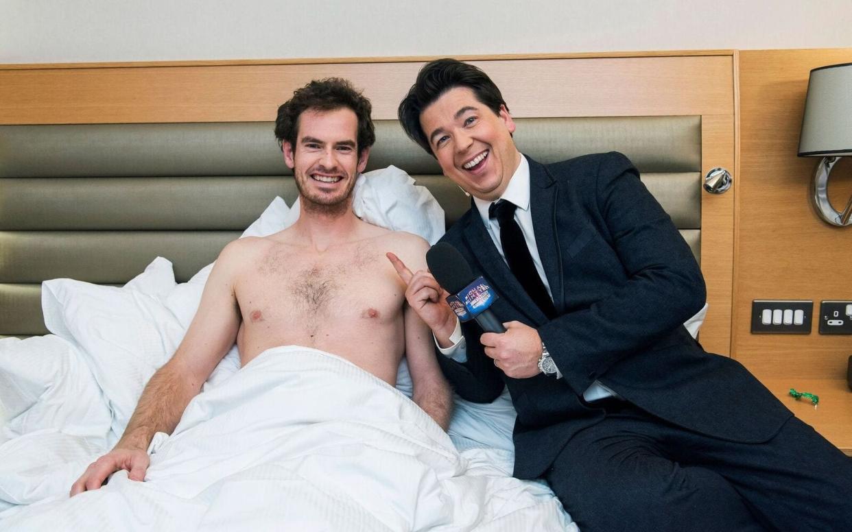 Michael McIntyre wakes a sleeping, shirtless Andy Murray to take part in his Midnight Gameshow - PA