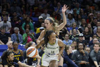 Indiana Fever guard Lexie Hull, center top, fouls Dallas Wings' Jaelyn Brown (18) during the second half of an WNBA basketball game in Arlington, Texas, Friday, May 3, 2024. (AP Photo/Michael Ainsworth)