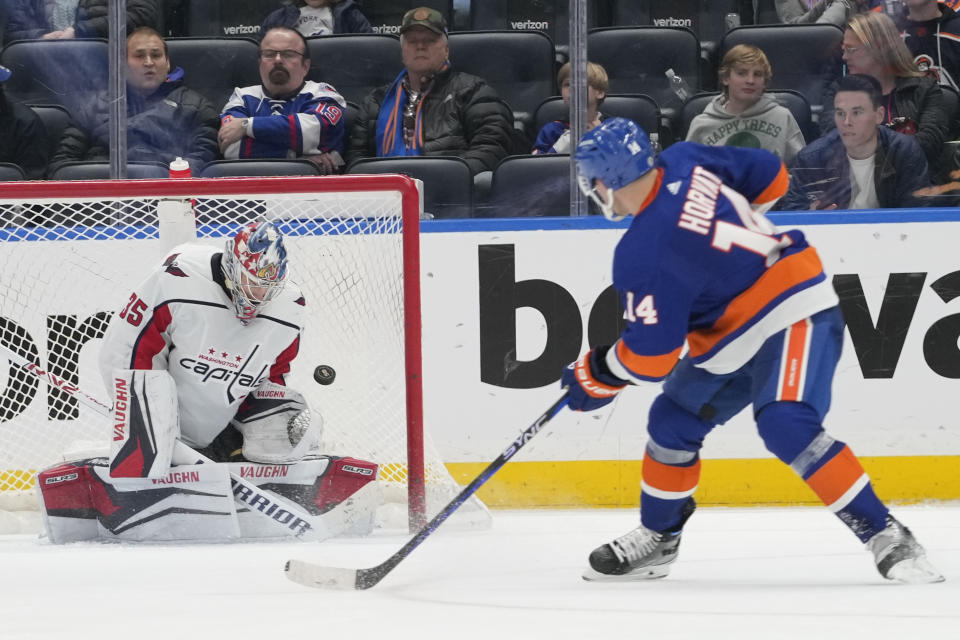 Washington Capitals goaltender Darcy Kuemper (35) makes a save against New York Islanders center Bo Horvat (14) during the third period of an NHL hockey game Saturday, March 11, 2023, in Elmont, N.Y. (AP Photo/Mary Altaffer)