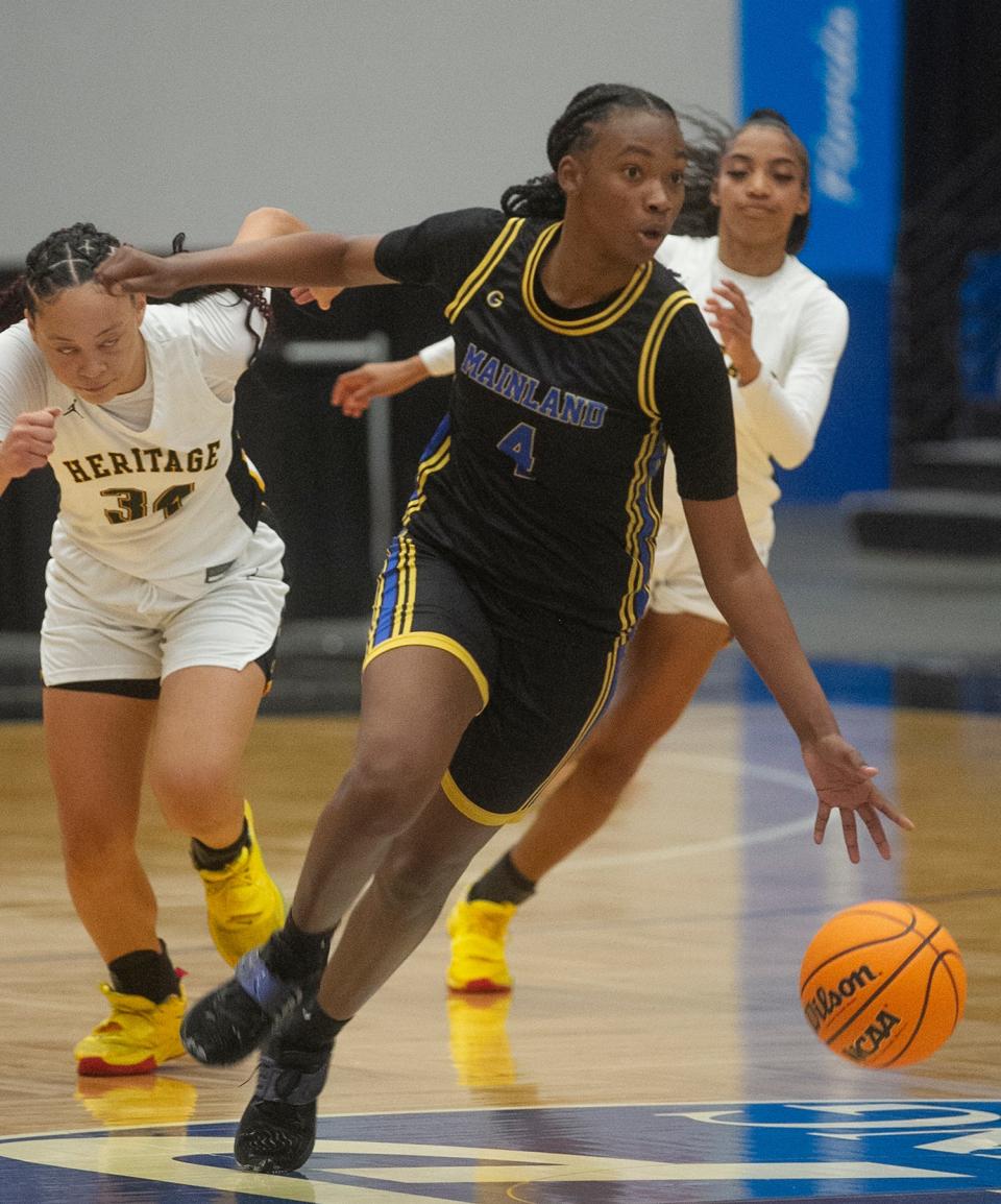 Mainland's Anovia Sheals (4) dribbles up the court against American Heritage during the Class 5A state championship game, Saturday, Feb. 25, 2023 in Lakeland.