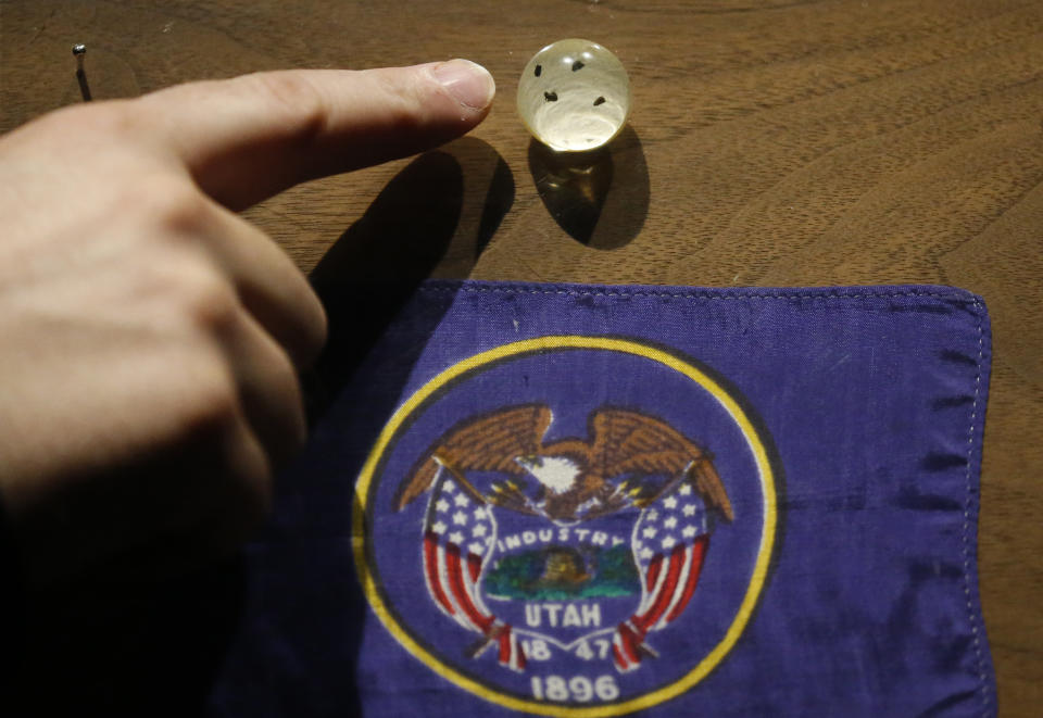 In this Wednesday, Aug. 22, 2018, photo, shows moon rocks encased in acrylic at the Clark Planetarium, in Salt Lake City. A former NASA investigator who has spent more than a decade tracking missing moon rocks is closing in on his goal of finding all 50 lunar samples gifted to U.S. states after Neil Armstrong's first steps on the moon. Each state got a tiny sample encased in acrylic and mounted on a wooden plaque, along with the state flag. (AP Photo/Rick Bowmer)