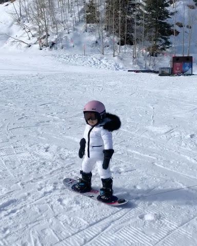 <p>Kylie Jenner/Instagram</p> Kylie Jenner and Travis Scott's daughter Stormi Webster snowboarding.