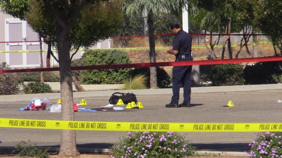 A Fresno officer collects evidence Thursday, Oct. 5, 2023, at the scene where an officer shot a man wielding a knife and pepper spray about a block east of Figarden Drive on Bullard Avenue.