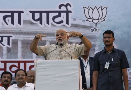 Hindu nationalist Narendra Modi, the prime ministerial candidate for India's main opposition Bharatiya Janata Party (BJP), gestures as he addresses his supporters during a public meeting in Vadodra, in the western Indian state of Gujarat, May 16, 2014. REUTERS/Amit Dave