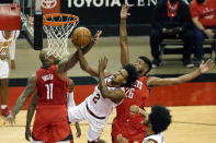 Cleveland Cavaliers guard Collin Sexton (2) puts up a shot between Houston Rockets forward P.J. Tucker (17) and center Justin Patton (26) during the first half of an NBA basketball game Monday, March 1, 2021, in Houston. (AP Photo/Michael Wyke)