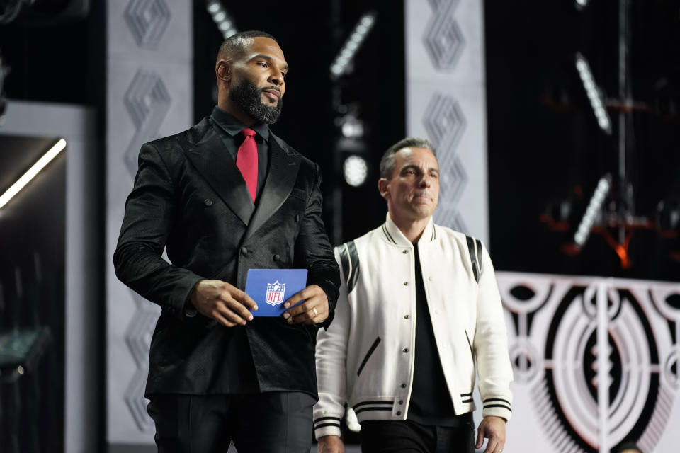 Matt Forte, left, and comedian Sean Sebastian Maniscalco announce Washington cornerback Kyler Gordon as the Chicago Bears pick during the second round of the NFL football draft Friday, April 29, 2022, in Las Vegas. (AP Photo/John Locher)