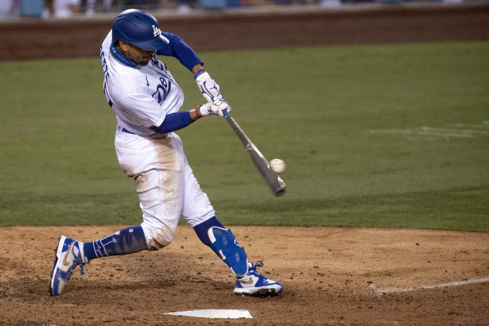 Los Angeles Dodgers' Mookie Betts hits a two-run home run during the eighth inning of the team's baseball game against the Colorado Rockies in Los Angeles, Friday, Sept. 4, 2020. (AP Photo/Kyusung Gong)