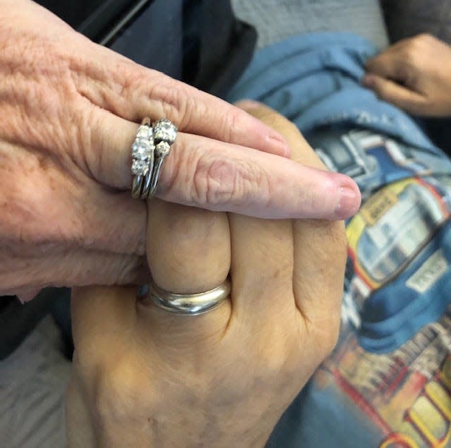 Cathy Kurtz holds her husband Jack's hand as she sits by his bedside.