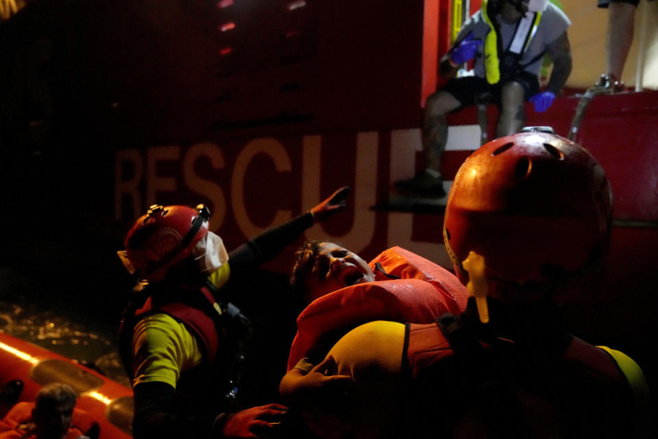 Spanish NGO Open Arms lifeguards rescue a migrant baby during a rescue operation in the Mediterranean sea early Sunday, Sept. 18, 2022. Around 200 migrants from Syria and Africa countries were rescued by NGO Open Arms crew members. (AP Photo/Petros Karadjias)