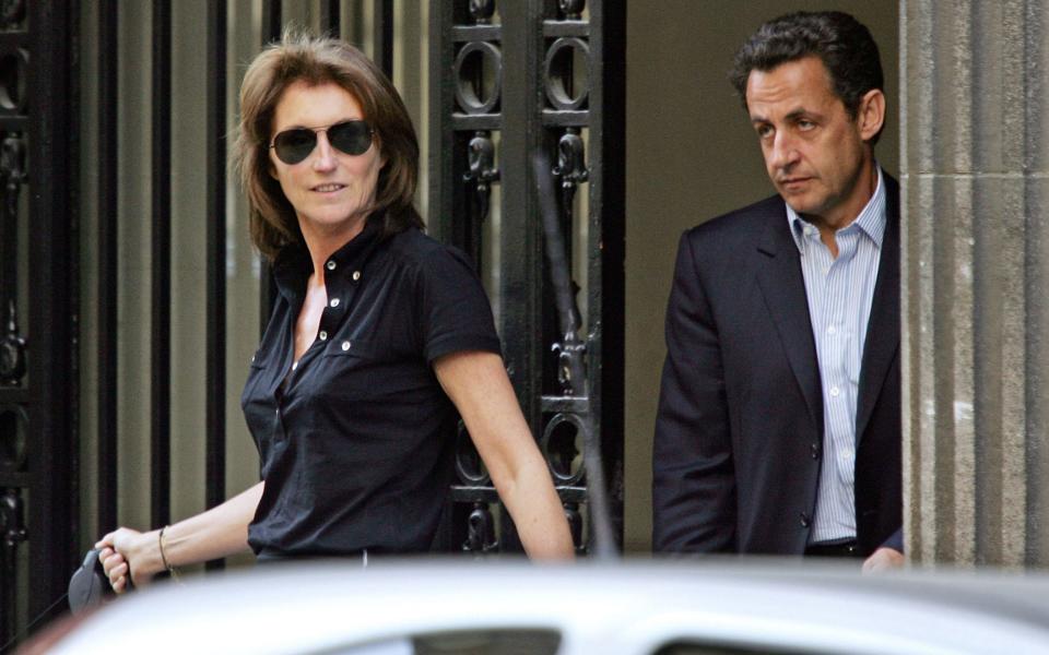 On April 22, 2007 then French right-wing UMP presidential candidate Nicolas Sarkozy (R) leaves his home with his wife Cecilia - THOMAS COEX/AFP